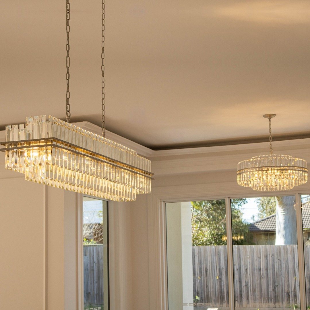 Ashton Collection - 120 Cm Bar Light - Champagne Finish over a dining table with Ashton Collection - 68cm Chandelier - Champagne Finish in the next room